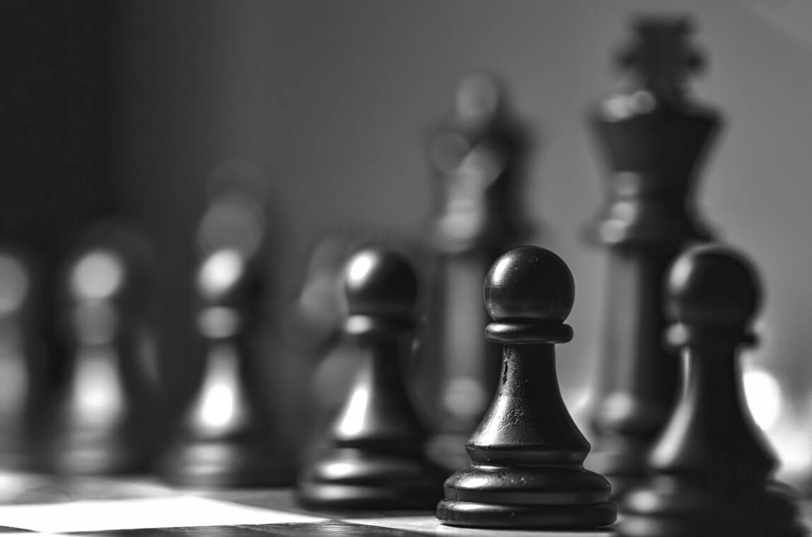 black chess pieces on a chess board